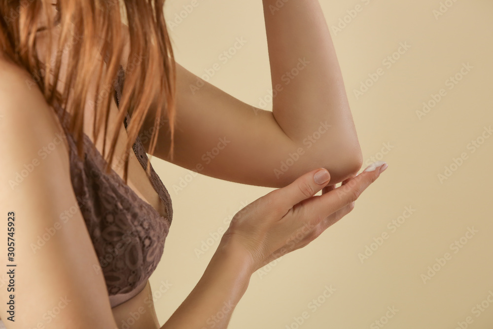 Woman applying cream on her elbow, skin care concept, eczema, rosacea, dry skin problem Woman applying cream on her elbow, skin care concept, eczema, rosacea, dry skin problem