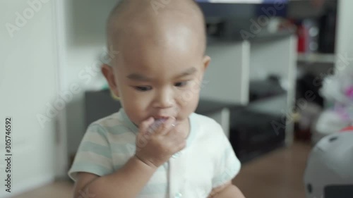 An infant follows the camera, the camera moves backwards.