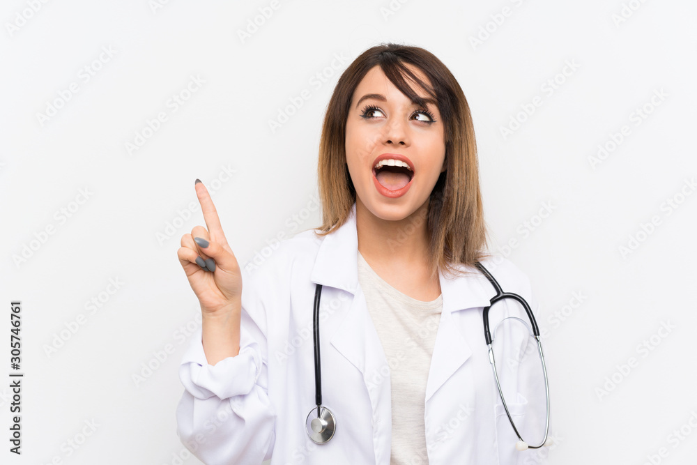 Young doctor woman over isolated background intending to realizes the solution while lifting a finger up