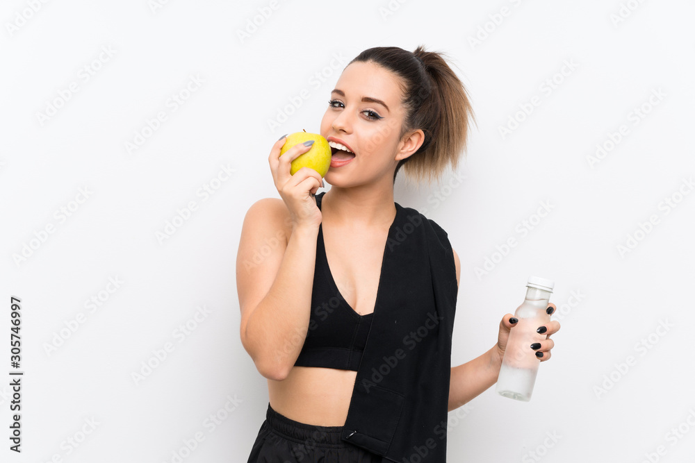 Young sport woman over white wall with an apple Young sport woman over white wall with an apple
