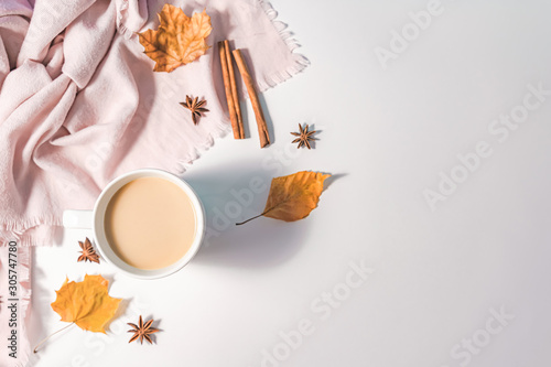 Autumn or Winter concept with pine and maple leaves  coffee cup   cinnamon  and scarf  Flat lay  top view.