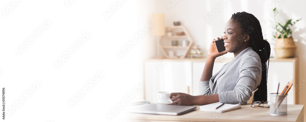 Relaxed Black Businesswoman Holding Cup And Talking On Cellphone At Workplace Relaxed Black Businesswoman Holding Cup And Talking On Cellphone At Workplace