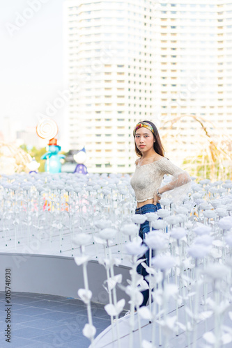 Portrait of beautiful sexy Asian woman in the white plastic flower field