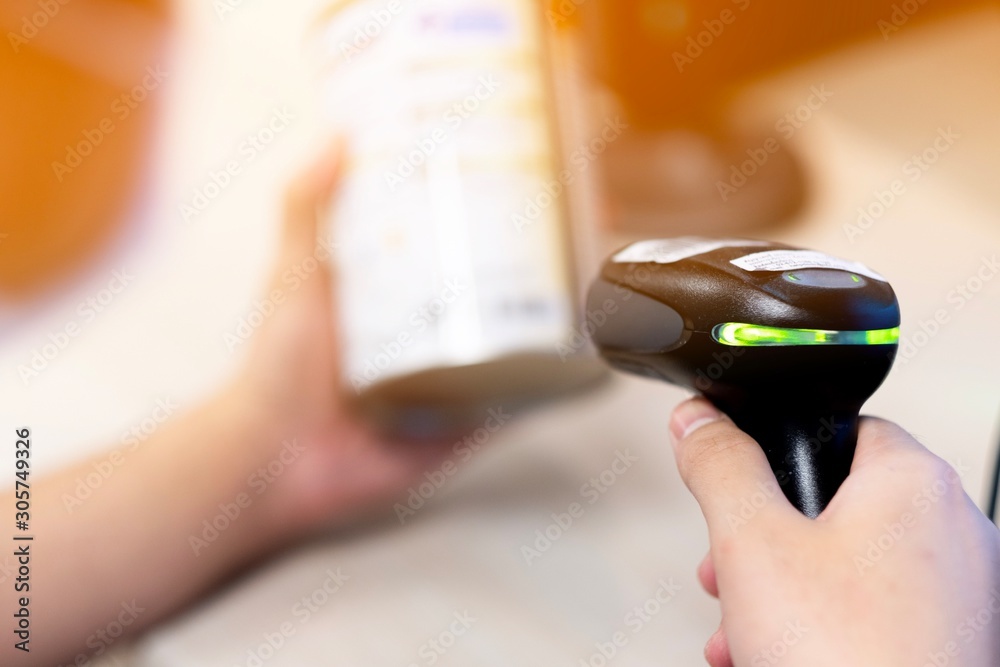 Pharmacist scanning barcode of drug in a pharmacy Stock Photo | Adobe Stock