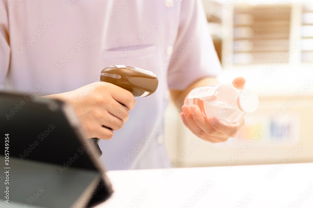 Pharmacist scanning barcode of drug in a pharmacy Pharmacist scanning barcode of drug in a pharmacy