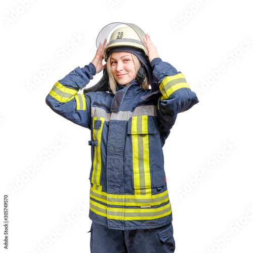 young smiling girl firefighter puts a helmet on his head. isolated on white background © suravikin@gmail.com
