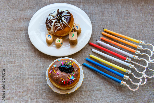 Festive donuts, menorah and dreidels are traditional symbols of Hanukkah Holi...