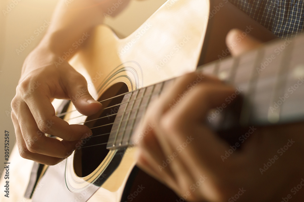 Fototapeta premium Man's hand playing acoustic guitar