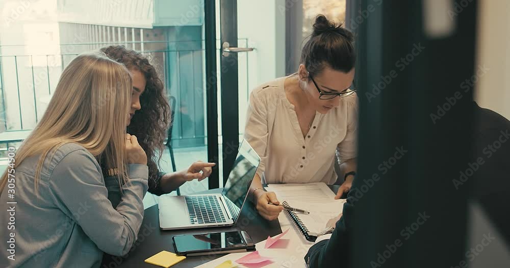 4K slow motion. Discussing of young business people. Mixed race creative team meeting in modern work space. We are stronger together.