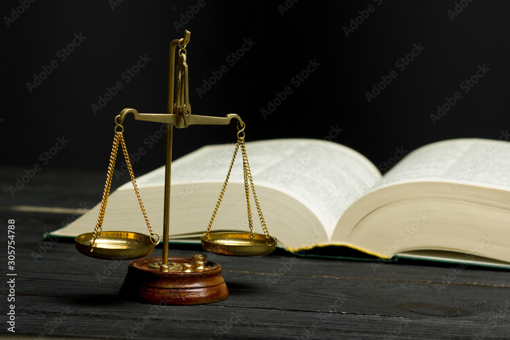 Law concept - Open law book with a wooden judges gavel on table in a courtroom or law enforcement office isolated on white background. Copy space for text. Law concept - Open law book with a wooden judges gavel on table in a courtroom or law enforcement office isolated on white background. Copy space for text.
