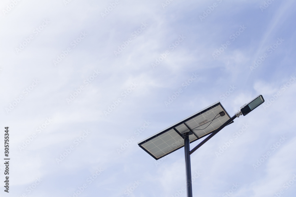The lamp post and photovoltaic panel with blue sky background The lamp post and photovoltaic panel with blue sky background