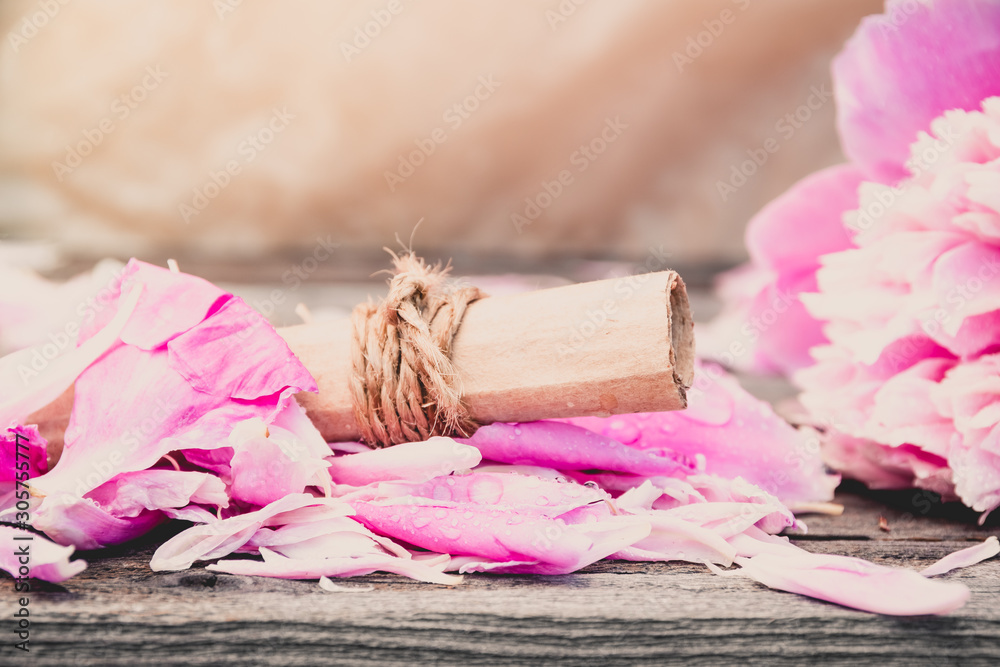 Roll of old paper on rose petals. Love letter, a wedding invitation. Romantic atmosphere of holiday. Roll of old paper on rose petals. Love letter, a wedding invitation. Romantic atmosphere of holiday.