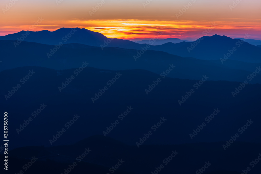 Beautiful sunrise in the mountains with a silhouette of the mountains
