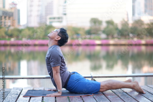 young man sitting on a bench in the park​ Exercise