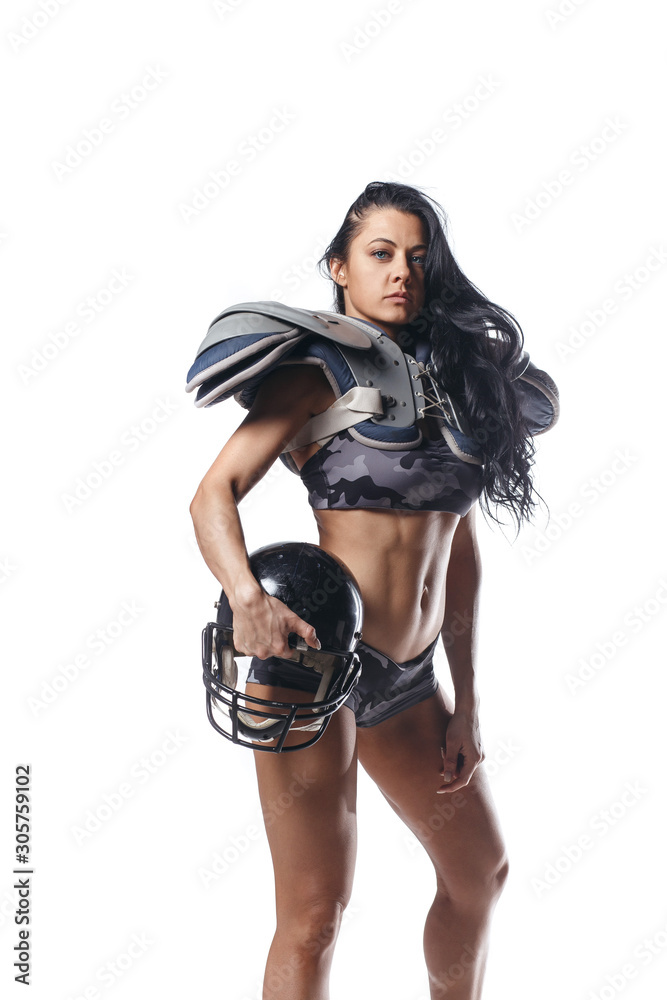 Quarterback girl with ball, helmet and armour with perfect sexy body isolated. Fitness woman of american football league player Quarterback girl with ball, helmet and armour with perfect sexy body isolated. Fitness woman of american football league player