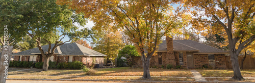 Panoramic single story bungalow houses in suburbs of Dallas with bright fall foliage colors © trongnguyen