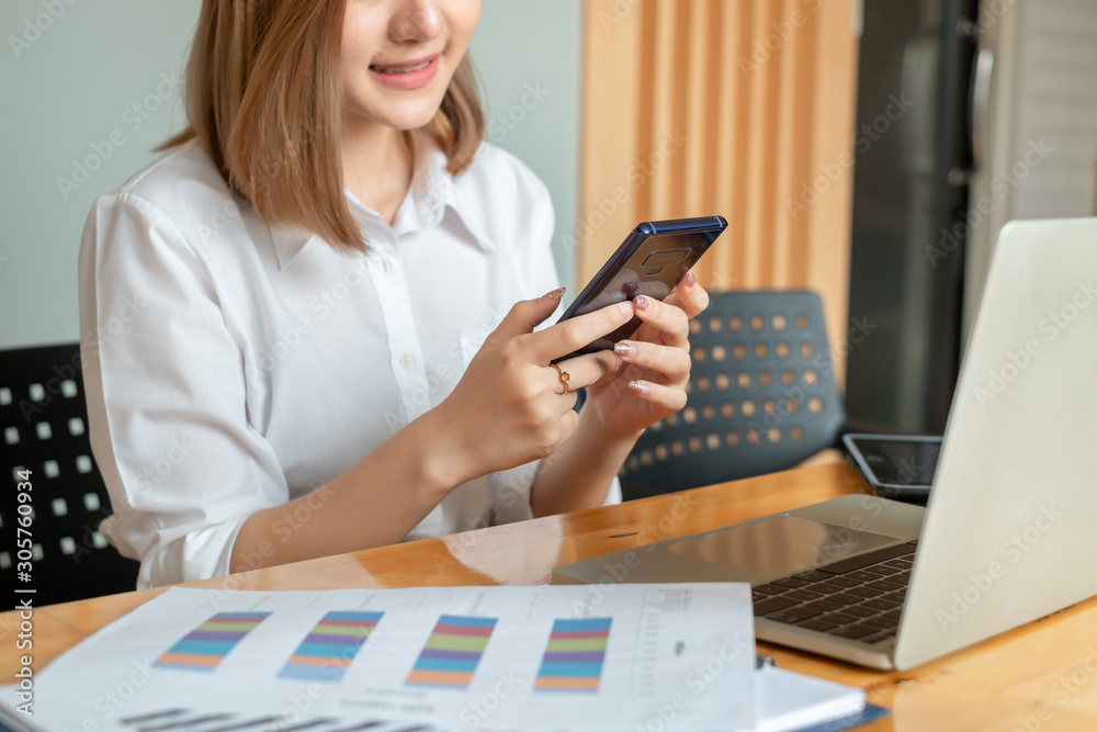 Close up hand businesswoman standing using app on smartphone at office. Close up hand businesswoman standing using app on smartphone at office.