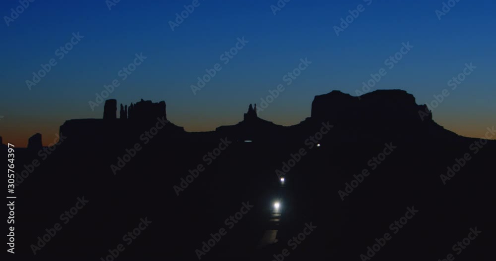Time lapse of vehicles driving through Monument Valley after sunset. Time lapse of vehicles driving through Monument Valley after sunset.