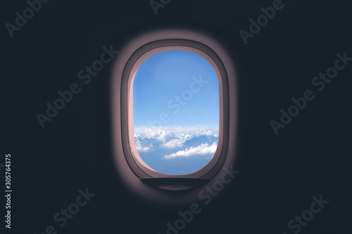 Airplane window. Mountain and clouds view