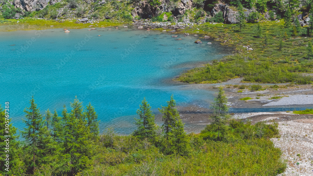 Blue lake in valley. Turquoise river in rocks. Hiking in mountains in Altai nature