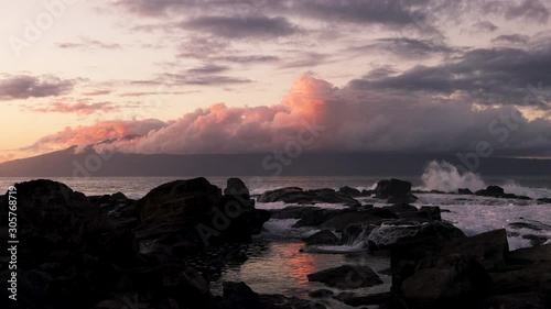 Waves Crashing Over Rocks At Sunset