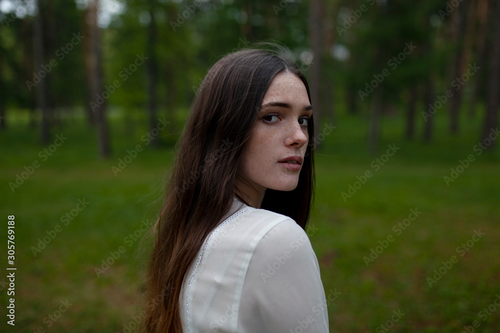 Young woman by forest