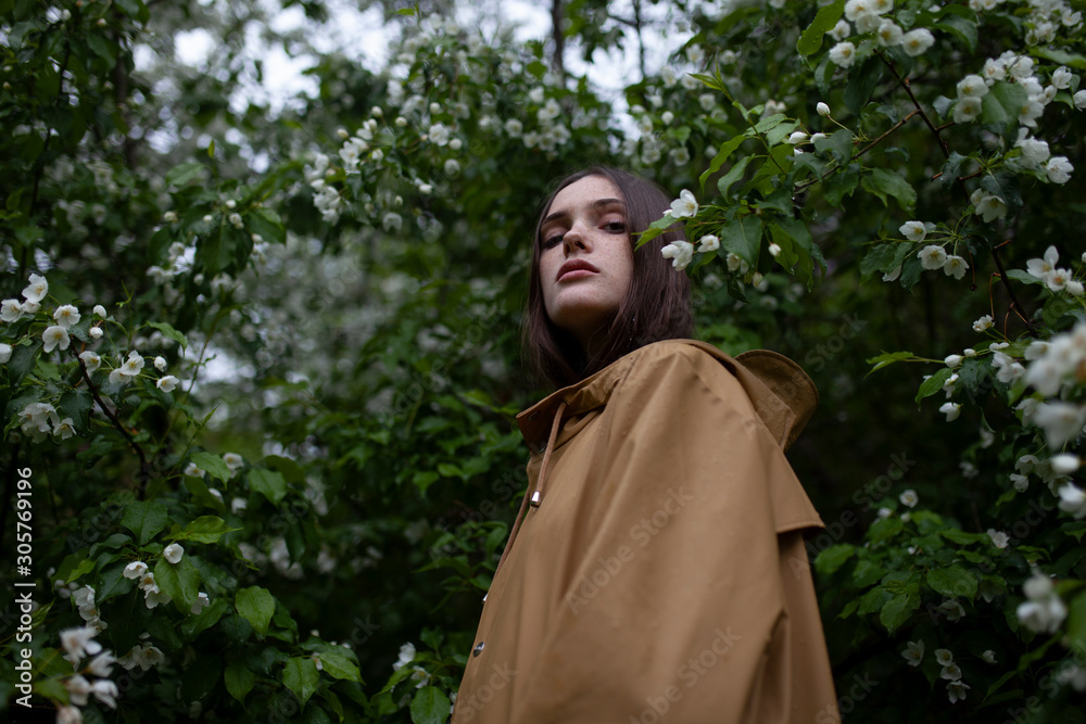 Low angle view of young woman by blossoms Low angle view of young woman by blossoms