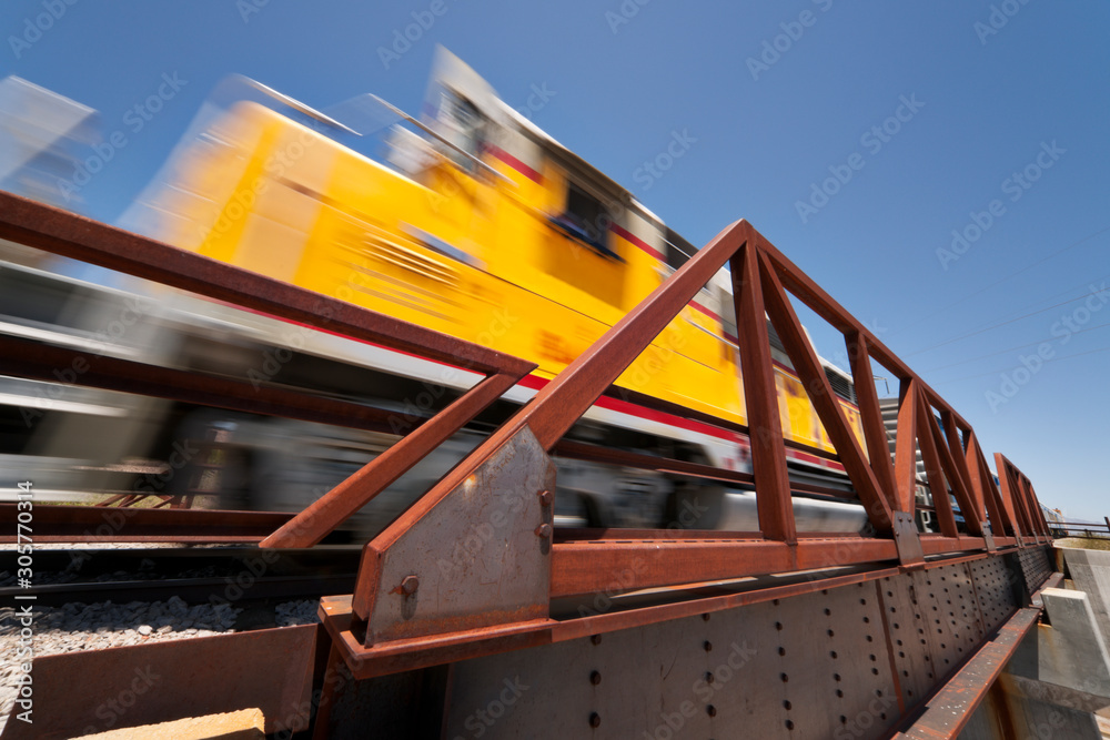 Freight train moving down the tracks with motion blur