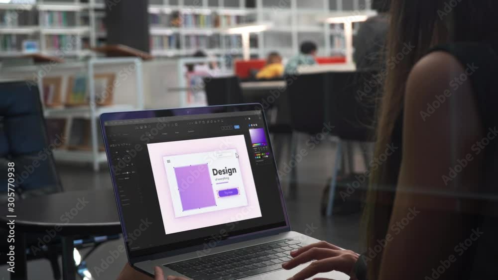 Young Woman Graphic Designer Works on Laptop, Looking at the Screen. Professional Creative Millennial Sitting at Desk in Office Studio Working 4K. Working in the Designer Program Close Up.