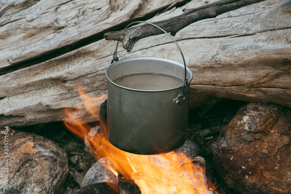 Tourist pot over the fire. Cooking in aluminum cookware. Survival in the wild. Tourist pot over the fire. Cooking in aluminum cookware. Survival in the wild.
