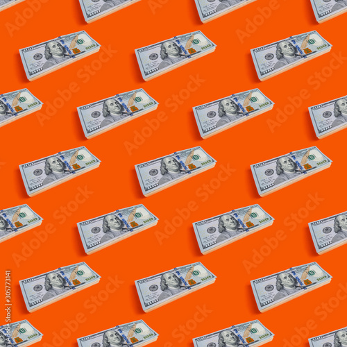 Seamless pattern of stack of hundred dollars on orange background