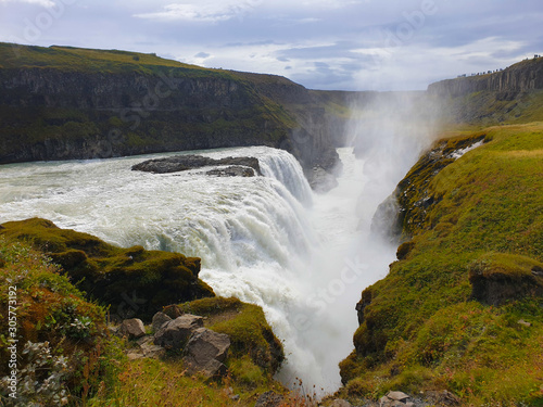 Wild waterfall in autumn landscape in Iceland 