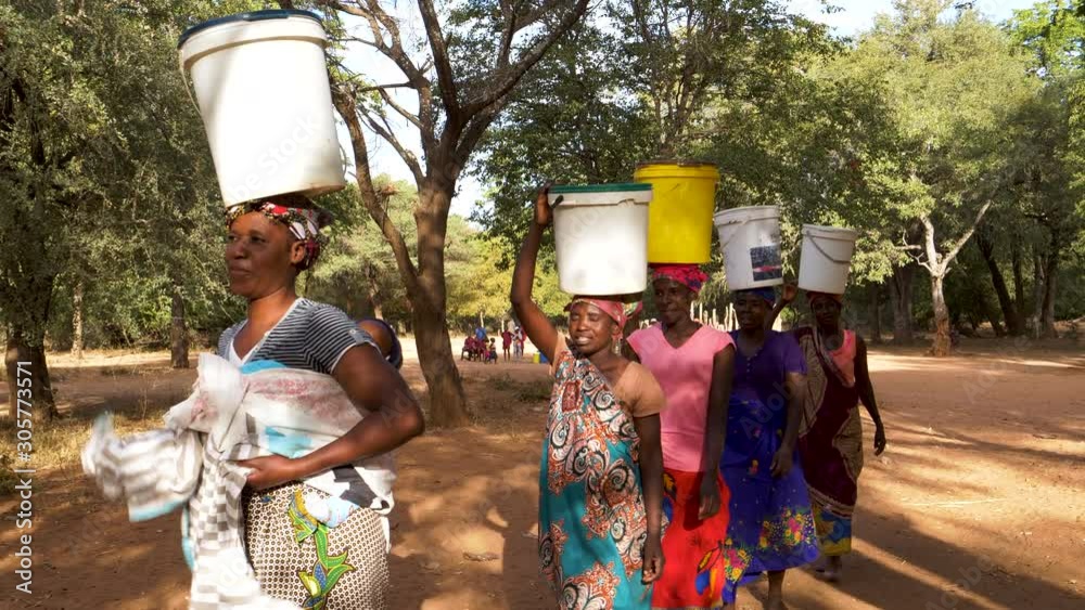 Water journey. Five woman and a baby make the long journey home carry