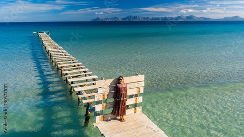 girl on a wooden pier in the sea Alcudia Majorca Spain