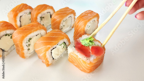 Beautiful Philadelphia Sushi Rolls Set with Salmon and Cream Cheese on white background. Sushi on white background.