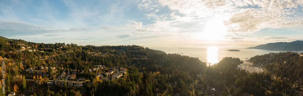 Horseshoe Bay, West Vancouver, British Columbia, Canada. Aerial view of residential homes near the Highway during a bright and sunny sunset in Fall Season.