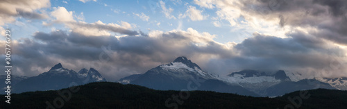 Striking and Dramatic Panoramic Canadian Landscape View of the Mountain Peaks during a cloudy sunset. Taken in Tantalus Lookout near Squamish and Whistler, North of Vancouver, BC, Canada. © edb3_16
