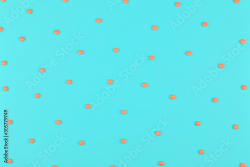 Medical background. Round small Pills pattern on light blue background.