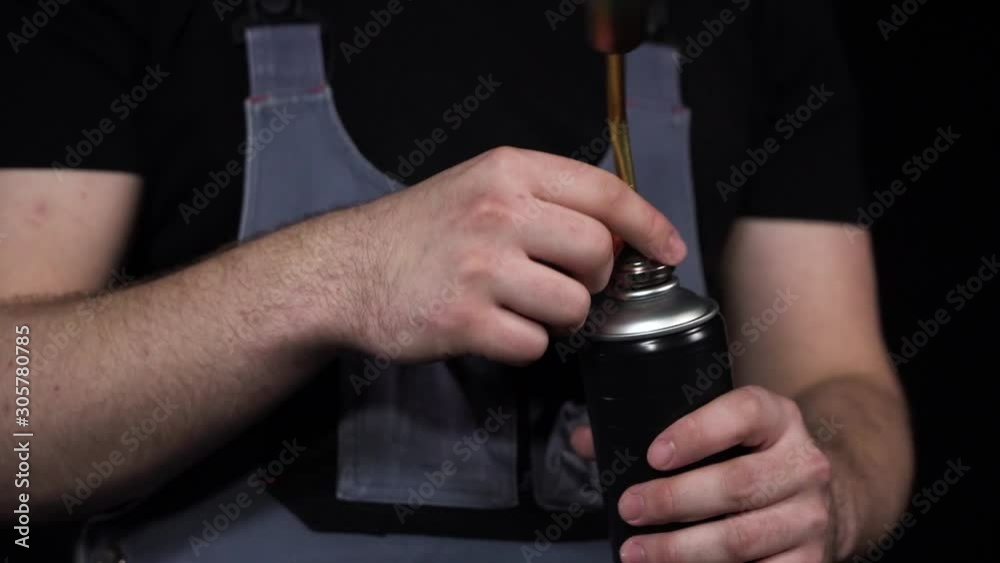 Man worker take manual hand gas burner and fit it on gas balloon.