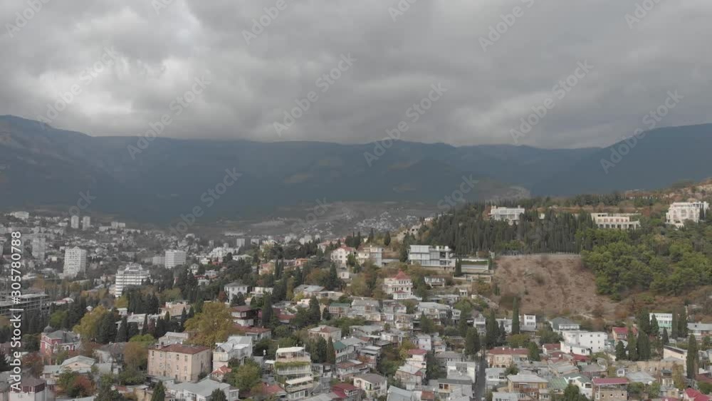 Aerial view of Yalta embankment from drone, city buildings on mountains, beautiful panorama of European resort, Crimea. Aerial view of Yalta embankment from drone, city buildings on mountains, beautiful panorama of European resort, Crimea.