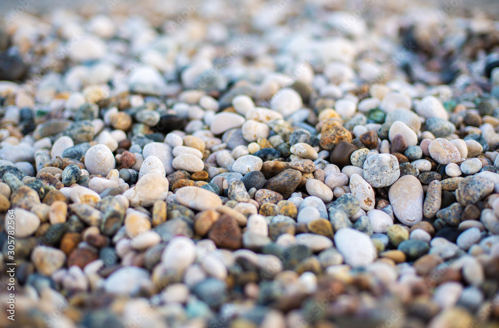 Pebbles beach as background. Different forms multicolor minerals as natural abstract texture backdrop. Summer  and holiday background