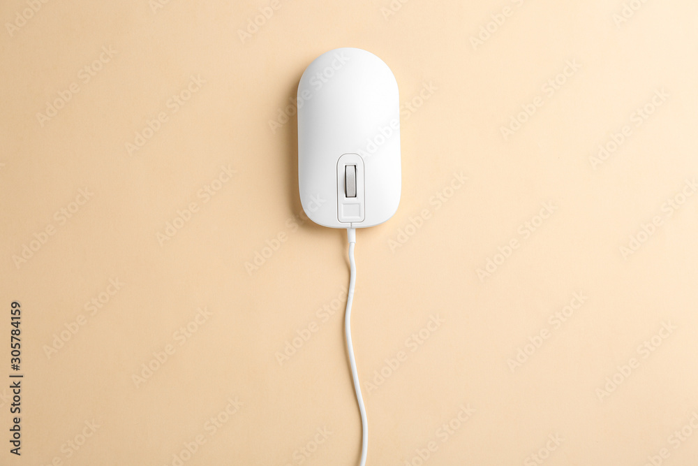 Modern wired optical mouse on beige background, top view Modern wired optical mouse on beige background, top view