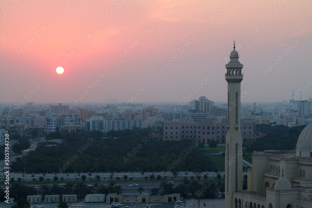 The Sun Setting over Manama City with the Minaret of Al Fateh Grand Mosque in Foreground