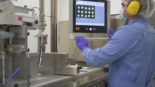 Wallpaper Mural Pharmacist control pharmaceutical manufacturing process at drug factory using computer data screen. worker. Check pharmaceutical production line Torontodigital.ca