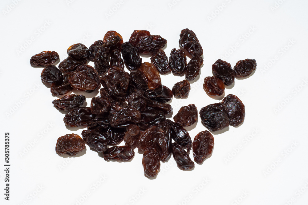 Raisins isolated on white background. Dried dark grapes. Diet healthy snack concept. Raisins isolated on white background. Dried dark grapes. Diet healthy snack concept.