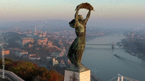 Budapest, Hungary, aerial view of historical landmark Liberty Statue and Budapest cityscape at sunrise.