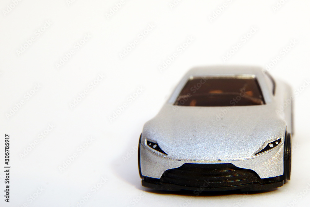 toy car . Collectible toy model silver sport car . Closeup of a silver baby car on a white background . toy car . Collectible toy model silver sport car . Closeup of a silver baby car on a white background .
