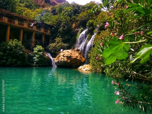 Beatiful waterfall and small lake in algeria with green trees