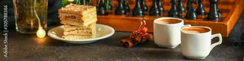 coffee  piece of cake  festive atmosphere  chess  Christmas lights  new year  menu concept. food background. top view. copy space