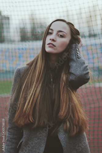 Obraz na płótnie Sensual portrait of beautiful young girl walking in the old abandoned stadium on cold autumn day w salonie